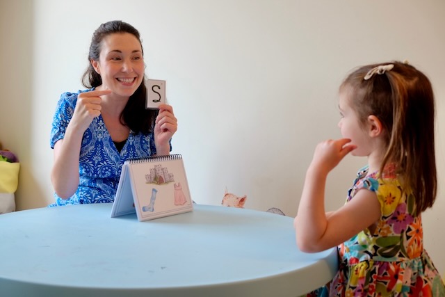 Little girl practicing speech sounds